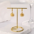 Close-up of vintage 18k gold plated sun face charm hoop earrings on a display stand - Sun Smile Face Pendant