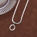 Minimalist silver letter O pendant necklace with flat snake chain on brown velvet - Letter O