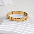Detailed close-up of golden stainless steel Italian charm bracelet with floral engravings - Full Gold Five-petal Flower (BD-159)