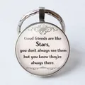 Detail of round keychain featuring glass gem with friendship quote about stars - Good friends are like Stars/Quote