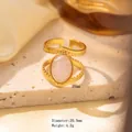 Golden titanium steel ring featuring an oval pink natural stone in an open design - Adjustable Open / Gold Double Band Hollow with Oval Pink White Stone (JOM25002)