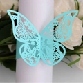 Light blue laser-cut butterfly napkin ring on white cloth for wedding decor - Tiffany Blue