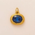Close-up of golden stainless steel pendant with an oval-cut deep blue zircon stone - December Oval Birthstone Pendant Only (Without Chain)