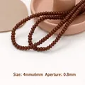Dettaglio di perline marroni 4x6mm con foro da 0,8mm per creazione gioielli fai-da-te - Perline distanziatrici marrone caffè (20 pezzi)