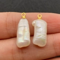 Natural white baroque irregular pearl pendant with a golden metal ring held on fingertip - No.5 (9x23mm)