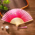 Pink gradient folding fan with butterfly and flower patterns and pink silk tassel - 37 Fluttering