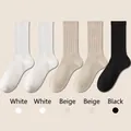 Five-pack of ribbed cotton mid-calf socks in white, beige, and black minimalist tones - One Size