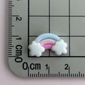 Macro shot of mini rainbow resin flatback with clouds showing size on scale mat - Blue Pink Rose