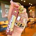 Luminous milk tea bear keychain with moving sand, pearls and brown silicone strap - Milk Tea Bear Square Bottle