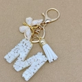 Letter M keychain with white stones and gold foil flakes featuring a white tassel - Letter M