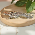 Vintage brass dragon ornament on a wooden tray with a traditional Chinese aesthetic - Dragon Fish