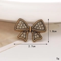 Macro shot of bronze vintage bow shoe charm with rhinestones and size dimensions - C489 Vintage Bowknot