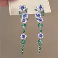 Macro detail of long floral drop earrings with blue enamel petals and green leaf accents - 4# Silver Earring Post - Blue - Green - White