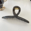 Detail view of a 15cm amber brown resin hair claw clip with a strong gold metal spring - Hanger (Approx 15cm) / Light Silver Grey