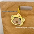 Plush capybara charm in yellow chick outfit hanging on bag handle, size 8x10cm - Yellow Chicken Capybara Style