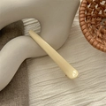 Close-up of cream resin seamless hair clip on elegant beige textured background - Glossy Off-White
