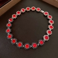 Detailed macro view of silver floral chain bracelet with red and black crystals - Style 13 Black Red
