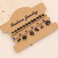 Detail of bohemian two-piece bracelet set with natural stones on a kraft card - Black Stone