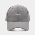 Close-up of grey baseball cap with white whatever letter embroidery and soft fabric texture - Adjustable / Gray