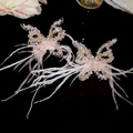 Detail of pink crystal butterfly pendant with soft white feathers on long sweater chain - Butterfly Ear Clip (HE25277) / Pink