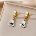 Close-up of golden heart earrings with evil eye shell inlay on a leather display - Long Heart Blue Eye
