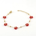 Golden stainless steel chain bracelet featuring delicate red beaded flowers and lobster clasp - Red Bracelet