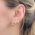 Three-piece gold-finished geometric C-shaped earring set shown on model's ear - Gold Polished Geometric Combo (5934101)