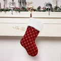 Detail of red satin Christmas stocking with gold lattice embroidery on fireplace - Red
