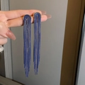 Detail of blue tassel earrings featuring elegant golden arch and long silk strands - Silver Earring Post-Blue