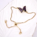 Detail of adjustable gold box chain with a purple crystal butterfly charm on white tray - Purple (Clear)