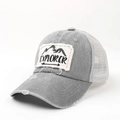 Close-up of grey washed cotton trucker hat with Explorer patch and mesh back - Adjustable / Light Gray