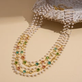 Dettaglio di collana dorata multistrato con perle sintetiche e pietre colorate su conchiglia - Stile Dorato (Collana-Oro-Multicolore)