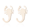 Detailed close-up of golden scorpion earrings with a polished metallic mirror finish - Gold