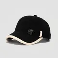 Close-up of black corduroy toddler baseball cap featuring a metal K letter badge - 50cm (1-3 Years) / Black