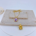 Detail of a gold turtle pendant with purple and white enamel work showing front and back views - Purple & White Enamel Turtle