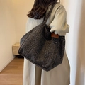 Large leopard print canvas tote bag shown worn on shoulder for stylish daily commuting - Black Leopard