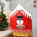 Close-up of a festive red snowman chair cover with Warm Wishes sign and striped trim - Snowman