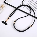 Detail of black nylon crossbody phone lanyard with gold metal buckle and adjusting piece - Black