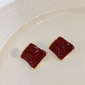 Red square enamel stud earrings with gold plating and wave edges on a ceramic plate - Burgundy
