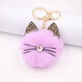 Pink plush cat ball keychain with leopard print ears and gold hardware on white pedestal - Taro Purple