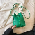Mini green woven drawstring bucket bag with slender shoulder strap and PU leather finish - Green