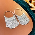 Detailed close-up of silver tassel earrings with delicate metal chains on velvet texture - Silver Tassel Earhook
