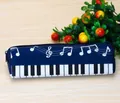 Dark blue piano note pencil case featuring black and white keyboard pattern and zip closure - Dark Blue
