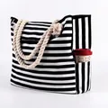 Detail of nautical striped canvas tote bag showing side pocket holding a coffee tumbler - Black and White Stripes