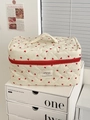 Detail view of quilted cream makeup bag with red hearts and a sturdy top handle - Red Heart - Makeup Case