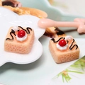 Detailed view of yellow resin miniature cakes with white cream and red berry toppings - Orange (Style D)