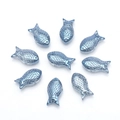Detailed view of nine deep blue fish-shaped crystal beads with metallic luster for DIY jewelry - Plated Ink Blue