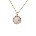 Detailed close-up of a gold-plated sun pendant with white marble enamel and star inlay - Sun/Star Style