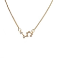 Close-up of gold Leo zodiac pendant necklace with sparkling clear zircon accents - K-Leo