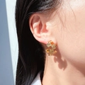 Retro golden C-shaped coin earrings with embossed portrait design on female model - Gold